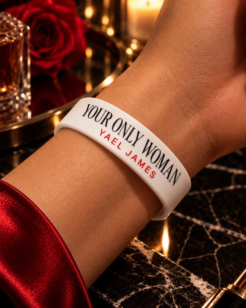 YOUR ONLY WOMAN bracelet by YAEL JAMES in white, worn on a wrist with red nails in a vintage lounge.