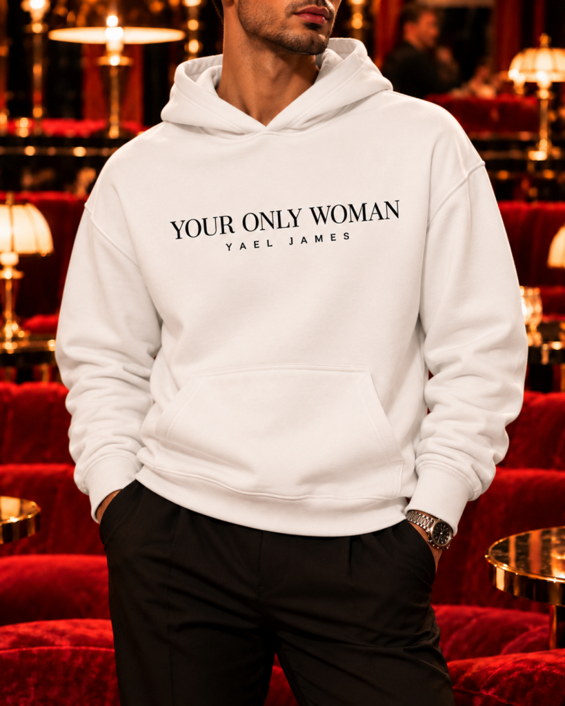 Front view of the white YOUR ONLY WOMAN hoodie for him by YAEL JAMES, with statement lettering across the chest and a kangaroo pocket.