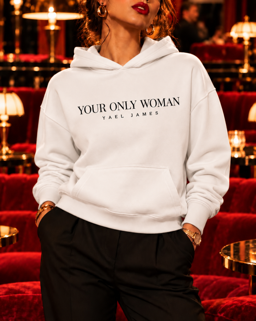 Front view of the white YOUR ONLY WOMAN hoodie by YAEL JAMES, worn by a model cropped from her red lips down.
